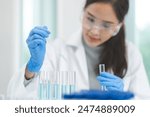 Medical development research laboratory, chemist or science scientist student hand in glove, drop water into pipette for test analysis liquid sample in clinic lab. Microbiology, analysing for medicine