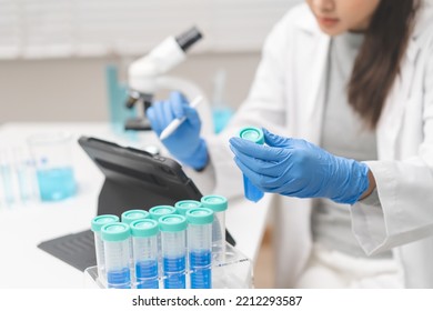 Medical Development Research Laboratory, Chemist Or Science Woman Scientist Student Hand Holding Pipette For Test Analysis Liquid Samples, Using Tablet In Lab. Microbiology, Analysing For Medicine.