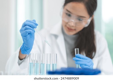 Medical development research laboratory, chemist or science scientist student hand in glove, drop water into pipette for test analysis liquid sample in clinic lab. Microbiology, analysing for medicine