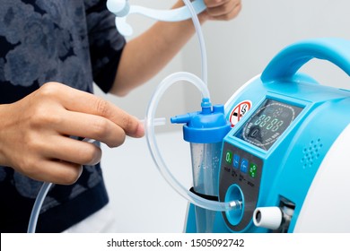 Medical Device Individual Blue White Portable Oxygen Cylinder To Put Gas For Patients With Respiratory Disorders, Woman Hand Try To Plug In The Rubber Tube To Tank