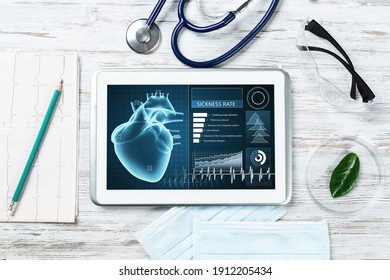 Medical diagnostics in hospital. Tablet computer with medical app interface on screen. Doctor workplace with stethoscope and cardiogram on wooden desk. Digital technology in cardiology clinic.