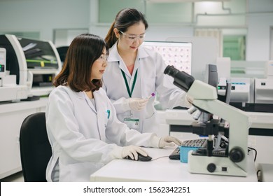 Medical Doctor Or Health Care Professional Working For Analyzing Blood Samples In Laboratory Of Scientific Research. Concept For Biology Chemistry HIV Hematology And Medical Equipments Safety Lab.