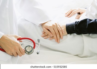 Medical Doctor Holding Patient's Hands And Comforting Her With Care, Doctor Supports Her Palliative Patient With Sympathy. (Selective Focus)