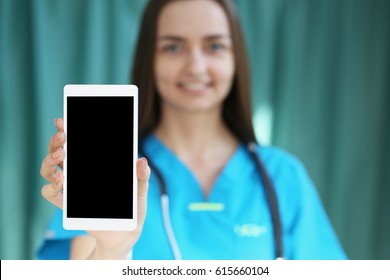 Medical Doctor Holding Smartphone In Hand, Photo With Depth Of Field