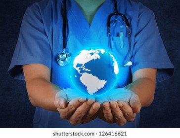 Medical Doctor holding a world globe in his hands as medical network concept - Powered by Shutterstock - Get 15% off with code: PIKWIZARD15