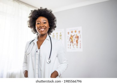 Medical Doctor Indoors Portraits. Portrait of a confident doctor working at a hospital. Waist up portrait of beautiful African-American nurse posing confidently while standing with arms crossed - Powered by Shutterstock