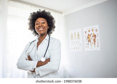 Medical Doctor Indoors Portraits. Portrait of a confident doctor working at a hospital. Waist up portrait of beautiful African-American nurse posing confidently while standing with arms crossed - Powered by Shutterstock