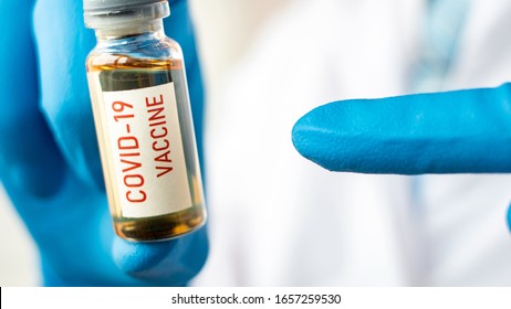 Medical Doctor Or Laborant Holding Tube With NCoV Coronavirus Vaccine For 2019-nCoV COVID Virus. Novel Coronavirus Originating In Wuhan, China. Coronavirus 2019-nCoV COVID Concept.