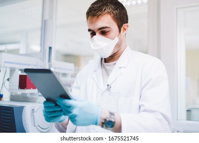 Medical Doctor In The Laboratory With Dna Machinery And Tablet Analysing Samples Of Covid19 Infectious Disease. Coronavirus