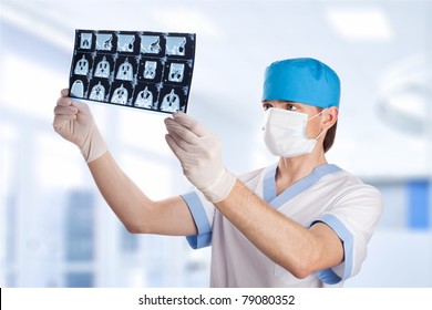 Medical Doctor Looking At CT Computer Tomography Scan Image In Hospital