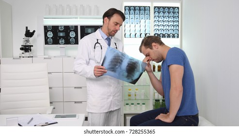 Medical Doctor Man Giving Bad News About Pulmonary X-Ray Result To A Sad Patient In Hospital