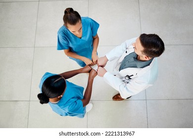 Medical, Doctor And Nurse Fist Bump With Hands Together To Show Support And Wellness Community. Above View Of Nursing, Healthcare And Medical Team Showing Success And Team Building At A Hospital