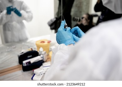 Medical Doctor Or Nurse Giving Coronavirus Vaccine Shot To Indian Teen Girl Over Blue Studio Background. Female Teenager In Face Mask Getting Covid-19 Vaccine, Participating In Immunization Campaign