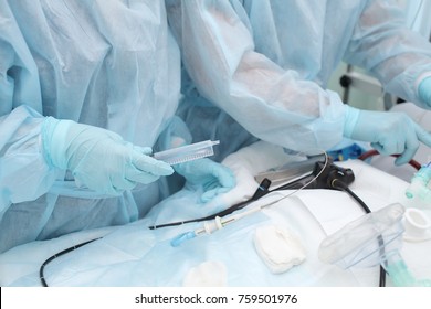 Medical doctor with nurse providing endoscopic procedure to the patient.
