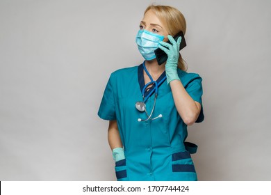 Medical Doctor Nurse Woman Wearing Protective Mask And Latex Gloves - Talking On The Phone