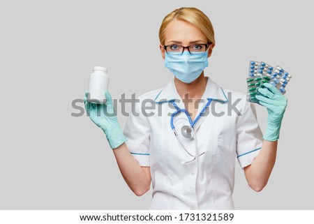 medical doctor nurse woman wearing protective mask and rubber or latex gloves - holding can of medicine and blisters of pills