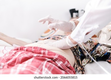 Medical Doctor Percussing Patient's Abdomen