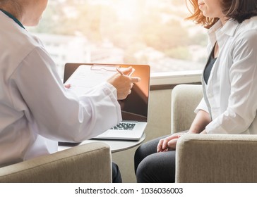 Medical doctor or physician consulting and diagnostic examining female patient's on woman's health in clinic or hospital healthcare service center with computer and note record