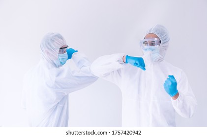 Medical Doctor, Scientist Wear PPE Suit Use Elbow Bump For Greeting In Laboratory.