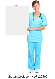 Medical Doctor Showing Blank Empty Billboard Sign Poster. Young Female Doctor / Nurse Standing In Full Body Isolated Over White Background. Asian / Caucasian Woman.