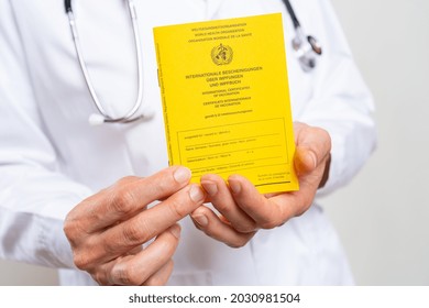 Medical Doctor Showing An International Certificate Of The Vaccination For Coronavirus, Covid-19 Or Flu, Measles Vaccine