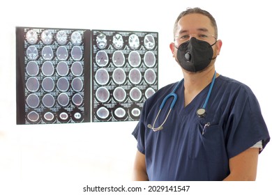 Medical Doctor Specialized In Neurology With A Mask And A Gown Uniform Reviews X-rays Of The Brain Or CT Scans As His Professional Work
