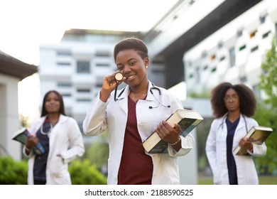 Medical Doctor Medical Student Holding Books And Stethoscope Whiles Smiling To The Camera. Medical School Graduation