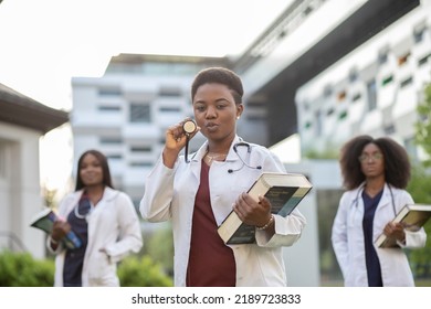 Medical Doctor Medical Student Holding Books And Stethoscope Whiles Smiling To The Camera. Medical School Graduation