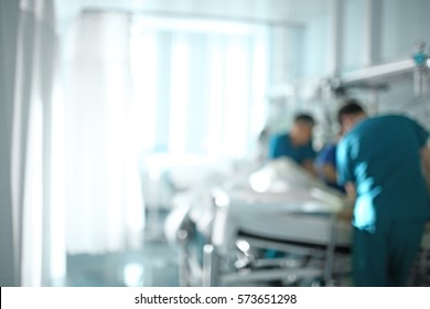 Medical Doctor Team At The Bedside Of Patient, Unfocused Background.