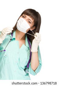 Medical Doctor Woman Or Nurse Taking Her Surgeon Mask Off, Isolated On White Background.