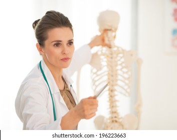 Medical Doctor Woman Teaching Anatomy Using Human Skeleton Model