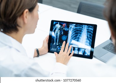 Medical Doctors Looking At A Screen Of Tablet PC. Medical Technology Concept.