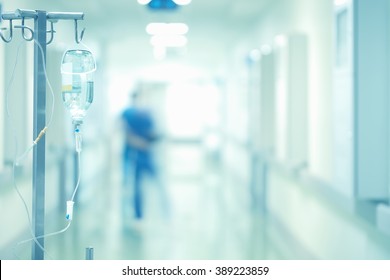 Medical Drip In The Blurred Background Of Doctors.