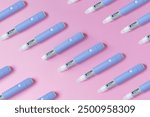 medical drug Ozempic injection lies on a pink background, top view. Medicine and weight loss, concept. injectors dosing pens for subcutaneous injection of antidiabetic medication or anti-obesity