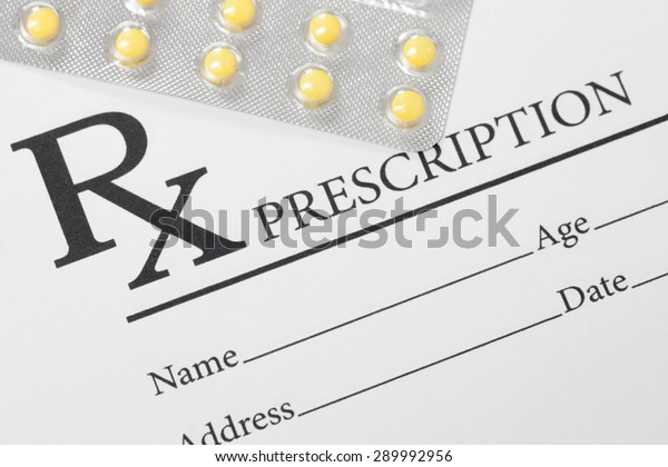 Medical\
drug prescription and pills over it - studio\
shot