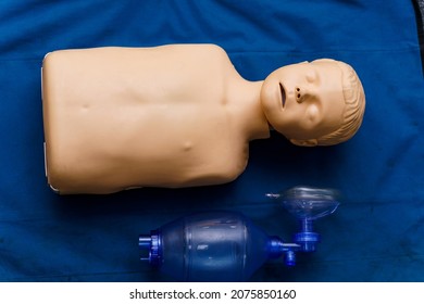 Medical dummy with oxygen mask on blue blanket. Photo from the side. First aid help concept. Close up