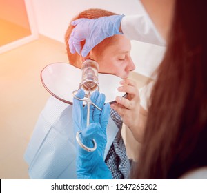 Medical Ear Washing With Water In Big Syringe. Ear Irrigation And Earwax Removal