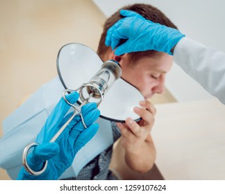 Medical Ear Washing With Water In Big Syringe. Ear Irrigation And Earwax Removal