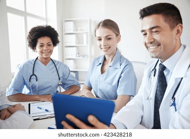 Medical Education, Health Care, People, Technology And Medicine Concept - Group Of Happy Doctors With Tablet Pc Computer Meeting At Medical Office