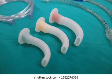 Medical Equipment For Airway Management : Orophalyngial Airway, Oral Airway And Endotracheal Tube On Green