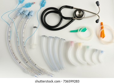 Medical equipment for airway management : stethoscope, syringe, oral airway and endotracheal tube on white background                        