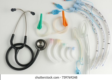 Medical equipment for airway management : stethoscope, syringe, oral airway and endotracheal tube on white background      
					