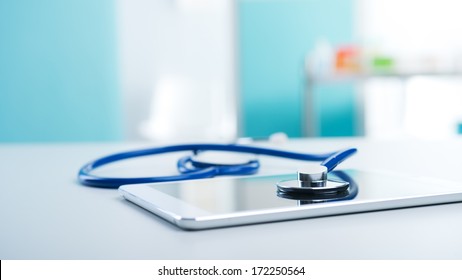 Medical Equipment: Blue Stethoscope And A Digital Tablet.