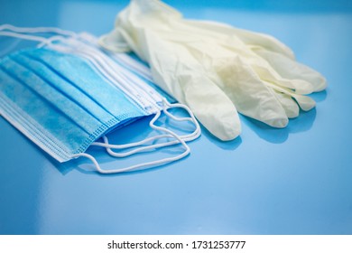 Medical Equipment With Face Masks And Clean White Gloves On A Sterile Blue Background