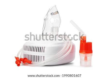 Medical equipment for inhalation therapy for asthma and respiratory diseases. Compressor nebulizer, respiratory mask and atomizing cup with mouthpiece isolated on white background.