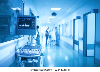 Medical Equipment On The Background Of Group Of Health Workers In The ICU.