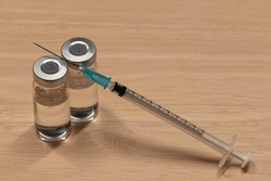 Medical Equipment That Includes Syringe With Hypodermic Needle And Vial Containing A Clear Liquid.