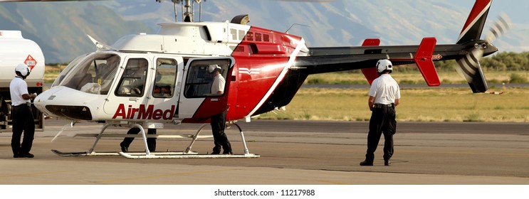 Medical Evacuation Helicopter And Crewmen At Airport