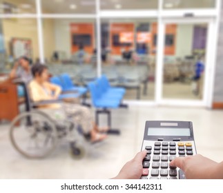 Medical Expense Concept By The Calculator With Blur Patient At The Hospital In Background