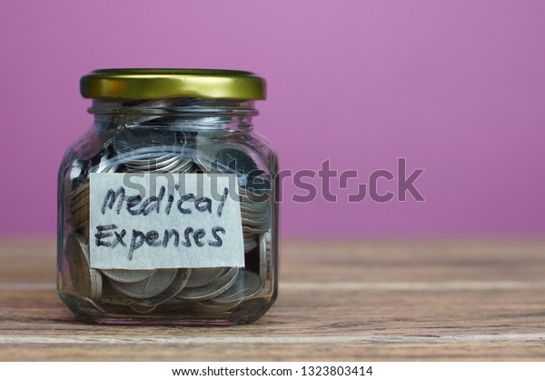 Medical\
Expenses in text sticker at coins\
bottle.